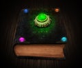 Mystical book with glowing gemstones