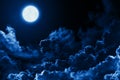 Mystical bright full moon in the midnight sky stars surrounded by dramatic clouds. Dark background twilight night sky