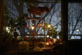 Mystical candle-lit room and trees in foggy twilight outside the window