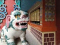 Mystical creature in a buddhist monastery. A white lion and prayer wheels. Royalty Free Stock Photo