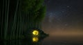 Mystical Glowing Cave Reflected on Lake in Forest Under Starry Sky Royalty Free Stock Photo