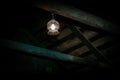 Mystical horror scary garret background to halloween. Old antique dirty wooden ceiling with beams and a lamp in the darkness in a Royalty Free Stock Photo