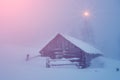 Mystical landscape with house in snow in the mountains in the fog at Christmas (new year, holidays, vacation, hiking, travel - co Royalty Free Stock Photo