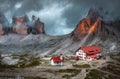 Mystical landscape with rocky mountains house and beautiful church at dusk Italian alps Tre Cime park in Dolomites Italy Royalty Free Stock Photo