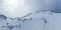 mystical light atmosphere at the hahnenkamm in tyrol with ski tracks