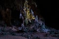 Mystical limestone cave chamber featuring illuminated stalactites, dramatic rock Royalty Free Stock Photo