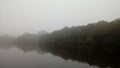 Mystical and magical landscape, fog, reflection of trees in the lake, pond, nature. Gray and silver sky. Royalty Free Stock Photo