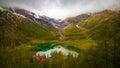 Mystical and marvelous view of the lake in Alps valley between mountains and green trees