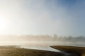 Mystical morning mist and haze over the river at dawn while fishing