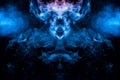 The mystical and mysterious pattern of evaporating blue smoke on a black background is similar in design to an alien head and eyes