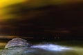 Mystical night landscape by the sea with a starry sky. Sea waves blurred in motion Royalty Free Stock Photo