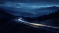 mystical night landscape winding road with car lights,surrounded by dark mountains and dark sky Royalty Free Stock Photo