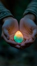 Mystical opal glowing between hands in a calming natural setting. Royalty Free Stock Photo