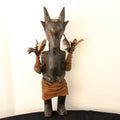 An mystical original African wooden sculplture with feathers in the shape of a goat