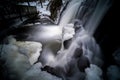 Mystical picture of small waterfall with ice on it.