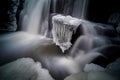 Mystical picture of small waterfall with ice on it.