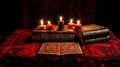 Mystical ritual book and burning candles on table in dark room for witchcraft and occult practices Royalty Free Stock Photo