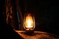 Mystical scene with old oil lamp in the forest.