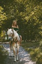 Woman with a horse at forest, mystical scene