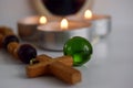 mystical still life. burning candles and a magic glass ball on a light background. the concept of divination, clairvoyance.