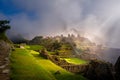 Mystical view on the Machu Picchu city ruins covered with fog