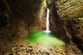 Mystical view of the rocky amphitheatre with a green pool and a white beam of water. 15-metre-high Kozjak Waterfall