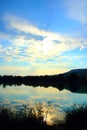 Mystical view with vegetation in the foreground, indistinct waters, Marche hills and azure sky