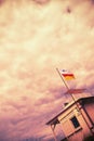 Mystically dramatic cloudy sky above a beach house with the number three, abstract