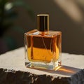 Golden Elegance A Luxurious Glass Perfume Bottle on Textured Stone Royalty Free Stock Photo