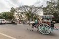 A horse cart with passengers riding through the streets in the city of Mysore Royalty Free Stock Photo