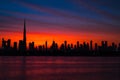 Mythical bloody red sky over Dubai. Dawn, morning, sunrise or dusk over Burj Khalifa. Beautiful colored cloudy sky over Royalty Free Stock Photo