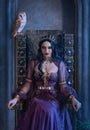 Mythical fantasy woman queen vamp sits on medieval ancient throne. Golden gothic crown on head. Elf girl princess evil