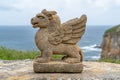 Mythical stone creature overlooking the ocean
