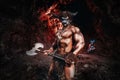 Mythological Minotaur half bull half man stands in a rock cave in an aggressive stance