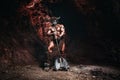 Mythological Minotaur half bull half man stands in a rock cave in an aggressive stance