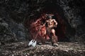 Mythological Minotaur half bull half man stands in a rock cave in an aggressive stance