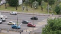 MYTISCHI, RUSSIA - JUNE 29 2021: Coloured automobiles and trucks drive along wide avenue crossing zebra crosswalk and stop at traf