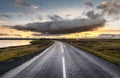 Myvatn, Iceland - dramatic cloud above empty road into sunset