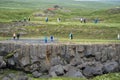 Tourists walk the walking trails to view Godafoss, a famous waterfall