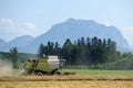 Combine harvester on grain field in the Salzkammergut Upper Austria, Austria