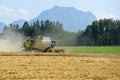 Combine harvester on grain field in the Salzkammergut Upper Austria, Austria Royalty Free Stock Photo