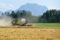 Combine harvester on grain field in the Salzkammergut Upper Austria, Austria