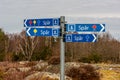 Signs marking directions for different colored walking paths..