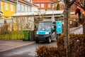 MÃÂ¶lndal, Sweden - January 13 2022: Small Postnord mail car delivering mail on a narrow street