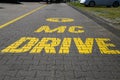 View on isolated McdonaldÃÂ´s drive in entrance mcdrive painted in yellow color on the ground