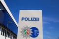 Isolated german Polizei logo in front of police station against blue sky