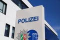 Isolated german Polizei logo in front of police station against blue sky