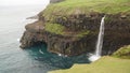 MÃÂºlafossur Waterfall in GÃÂ¡sadalur village on a misty day in bad weather on the Faroe Islands in Denmark. Royalty Free Stock Photo