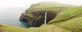 MÃÂºlafossur Waterfall in GÃÂ¡sadalur village on a misty day in bad weather on the Faroe Islands in Denmark.