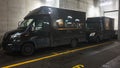 MÃÅNCHEN, GERMANY - DECEMBER 2019: Two black trucks of package delivery company United Parcel Service of America, Inc. UPS